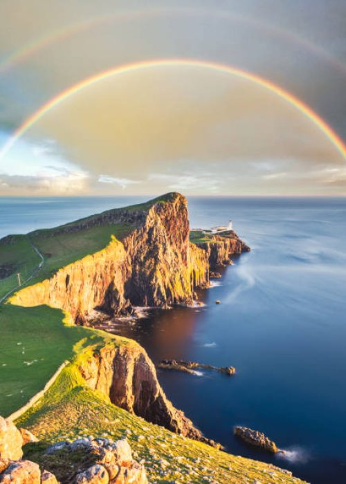Wonderful sunset with rainbow at the Neist point lighthouse in Scotland